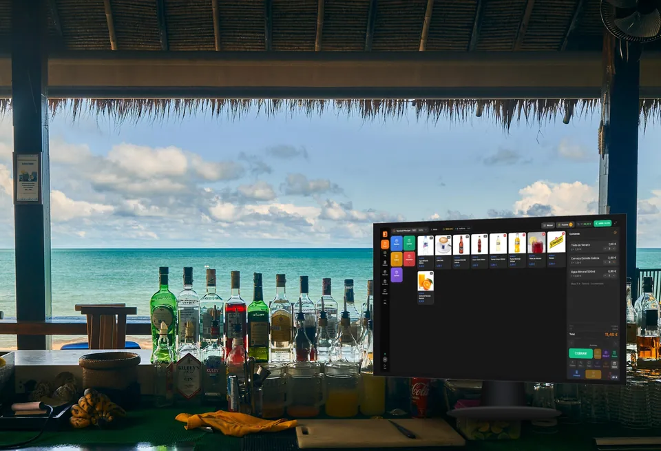 Barra de un chiringuito frente al mar con un TPV TakumiPOS cobrando una comanda de 11,40 €
